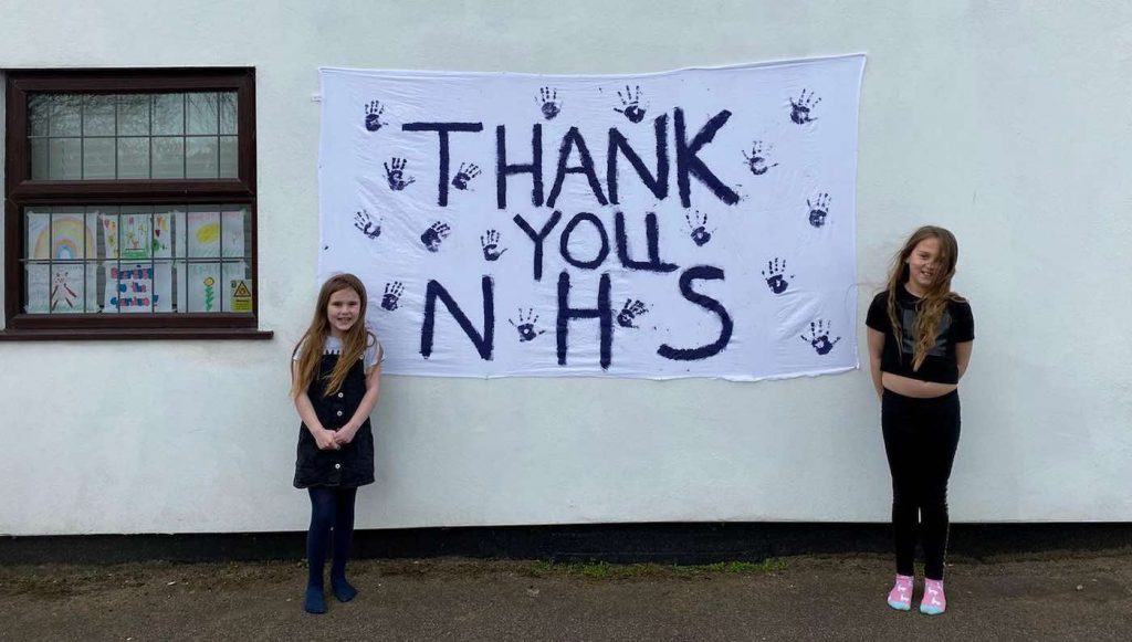 girls with Thank you NHS sign SWNS 1024x581 1